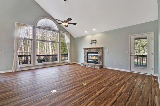 unfurnished living room featuring wood finished floors, plenty of natural light, a fireplace, and ceiling fan