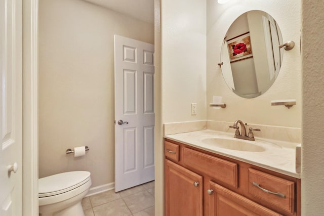 bathroom with tile patterned flooring, toilet, and vanity