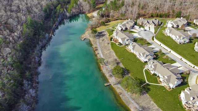 birds eye view of property with a forest view, a residential view, and a water view