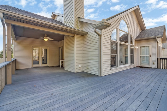 deck with a carport, a ceiling fan, and french doors