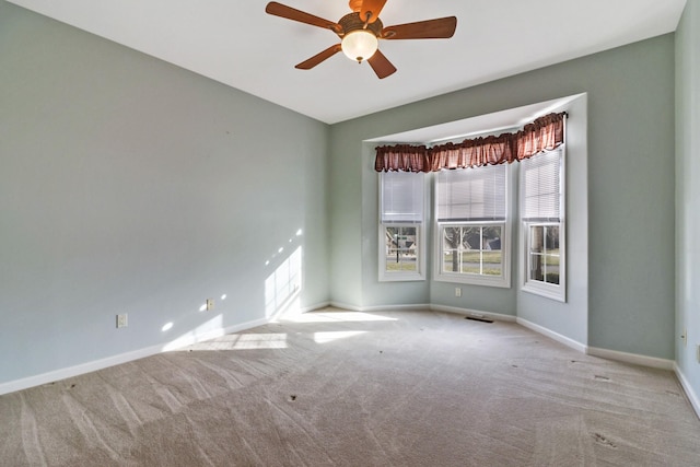 unfurnished room with a ceiling fan, baseboards, and carpet floors