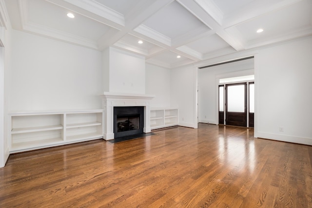 unfurnished living room with beamed ceiling, a fireplace with flush hearth, coffered ceiling, and wood finished floors