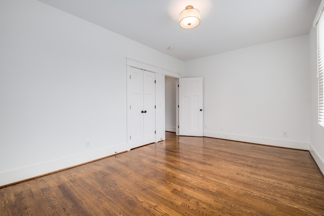 unfurnished room featuring wood finished floors and baseboards