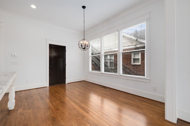 unfurnished dining area with wood finished floors, visible vents, baseboards, recessed lighting, and a chandelier