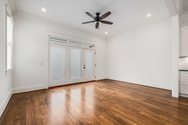 interior space featuring dark wood finished floors, baseboards, and ornamental molding