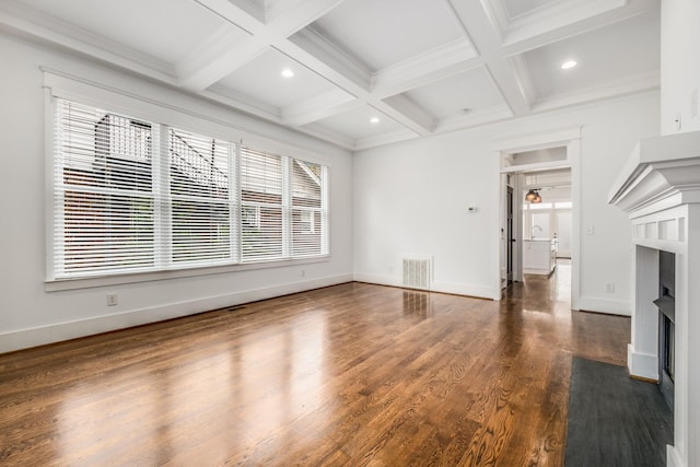 unfurnished living room with visible vents, beam ceiling, dark wood-style flooring, and a fireplace with flush hearth