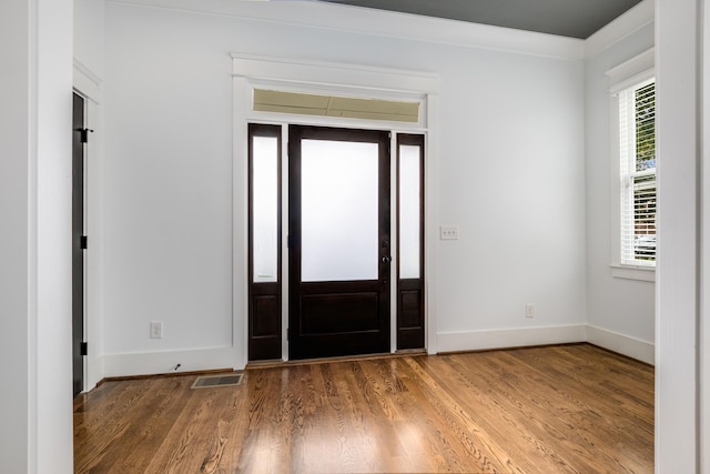 entryway with visible vents, baseboards, and wood finished floors