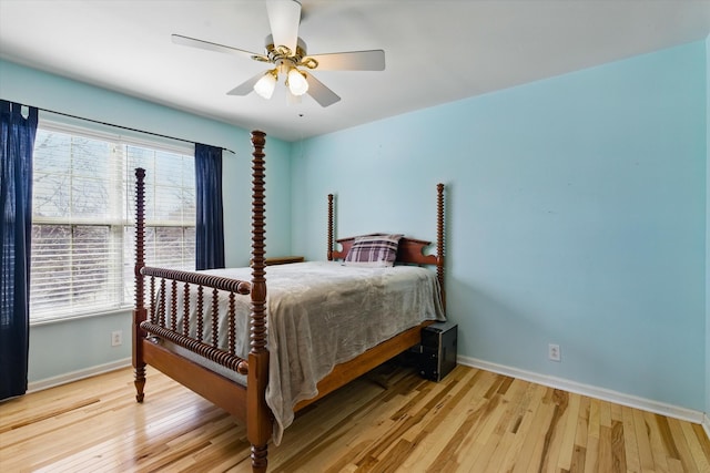 bedroom featuring light wood-type flooring, baseboards, and a ceiling fan