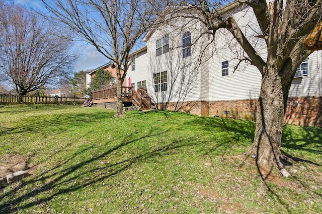 view of yard with a deck and fence