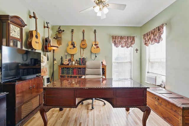 home office featuring cooling unit, wood finished floors, and a ceiling fan