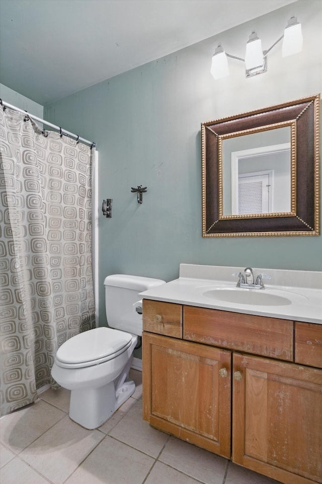 bathroom featuring curtained shower, toilet, vanity, and tile patterned flooring