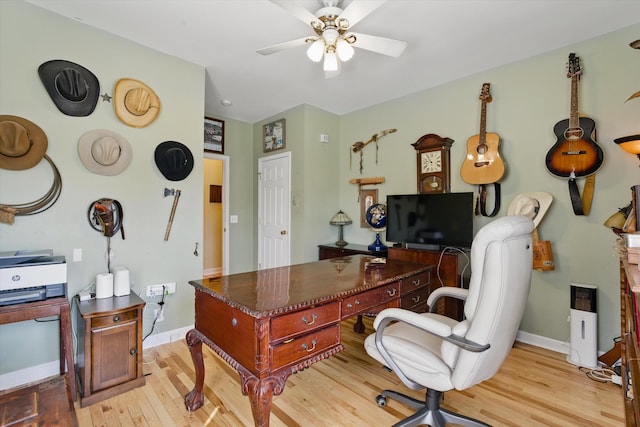 office area with light wood-type flooring, baseboards, and a ceiling fan