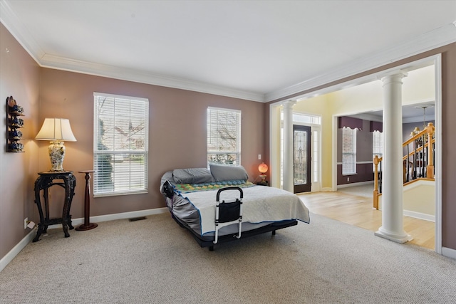 carpeted bedroom featuring visible vents, ornamental molding, baseboards, and decorative columns