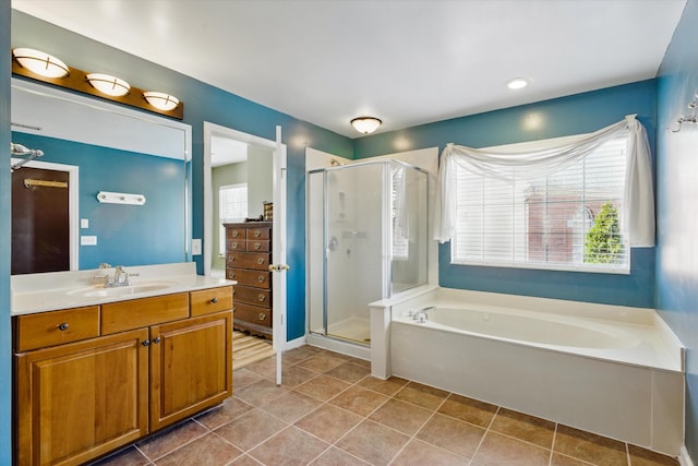 full bathroom with tile patterned floors, a garden tub, a stall shower, and vanity