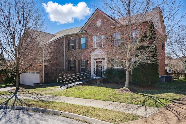 colonial-style house with a front yard, a garage, fence, and brick siding