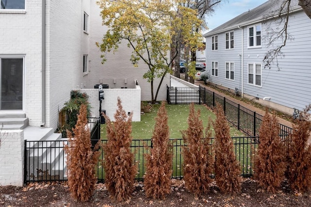 view of yard with a fenced front yard and entry steps