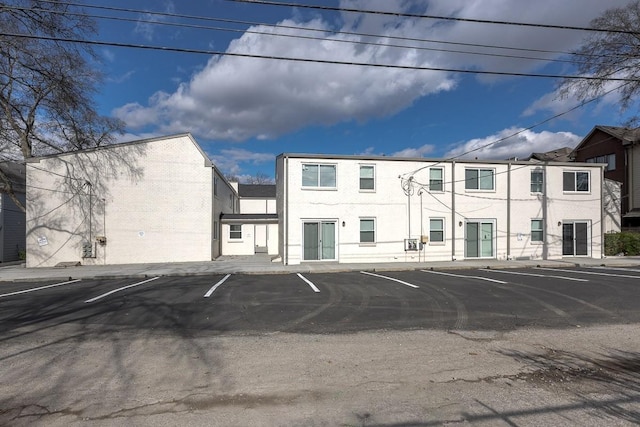 view of building exterior with uncovered parking