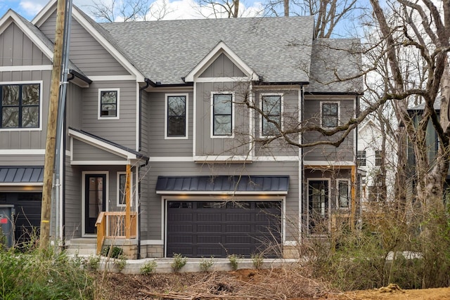 view of front of house with board and batten siding, a shingled roof, and a garage