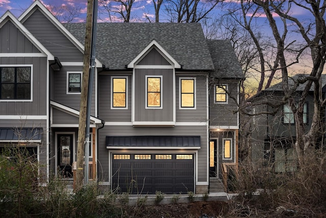 view of front of property featuring board and batten siding, a shingled roof, and a garage