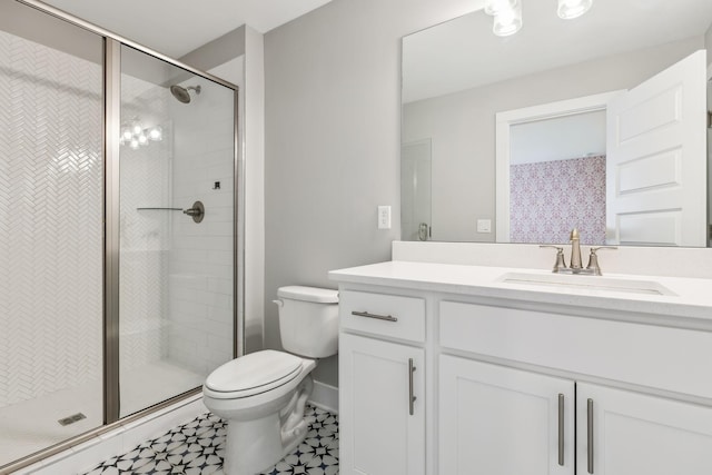 bathroom featuring baseboards, toilet, a stall shower, and vanity