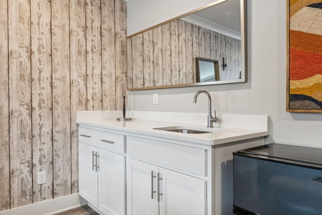 kitchen with a sink, light countertops, and white cabinetry