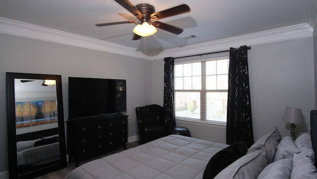 bedroom with visible vents, crown molding, and a ceiling fan