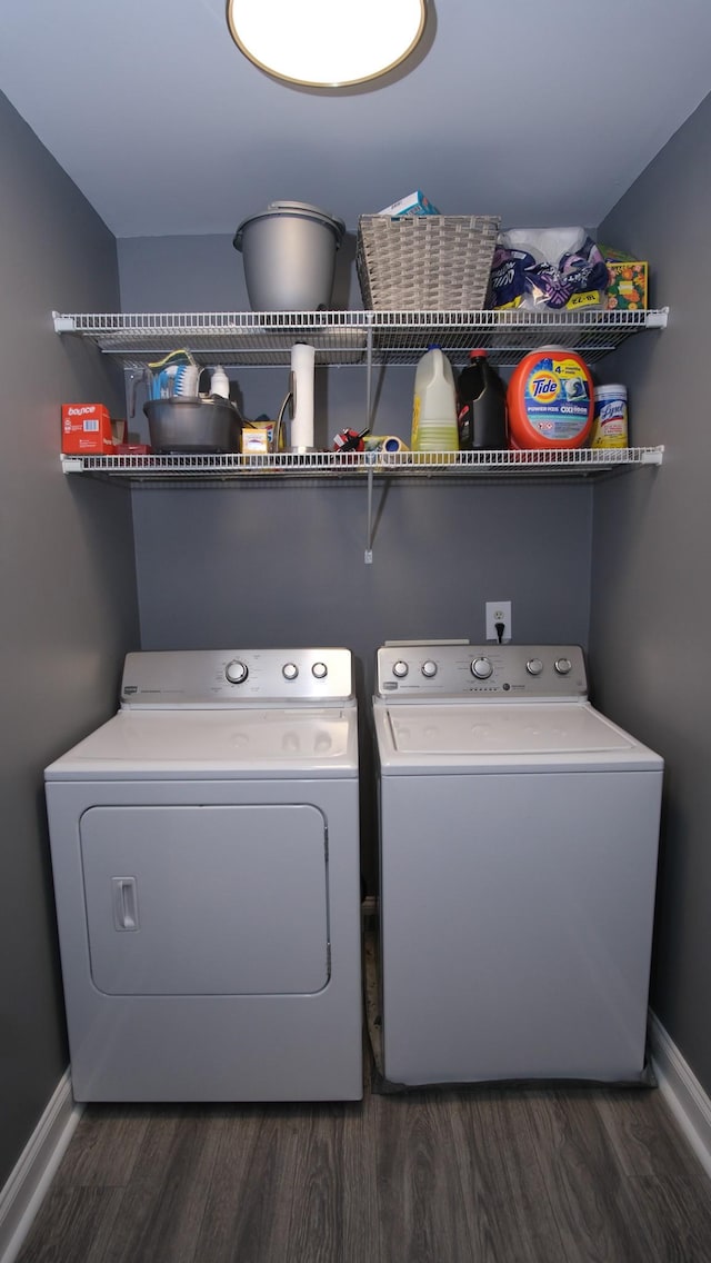 laundry area with baseboards, wood finished floors, laundry area, and washer and clothes dryer