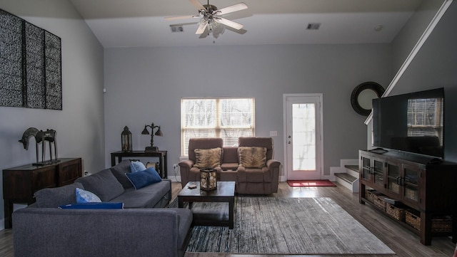 living room with visible vents, wood finished floors, and a ceiling fan