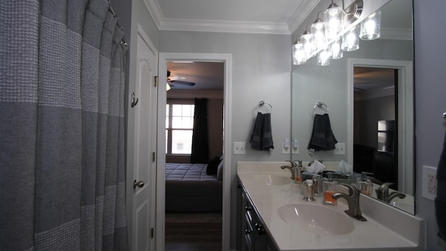 ensuite bathroom featuring crown molding, connected bathroom, double vanity, and a sink