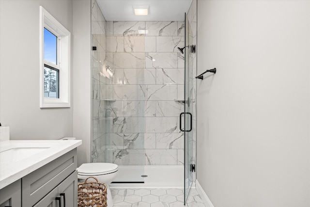 full bath with vanity, toilet, baseboards, and a stall shower