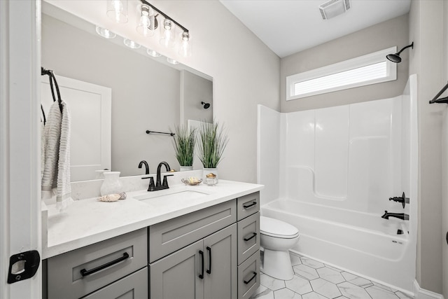 full bath featuring vanity, visible vents, bathtub / shower combination, tile patterned floors, and toilet