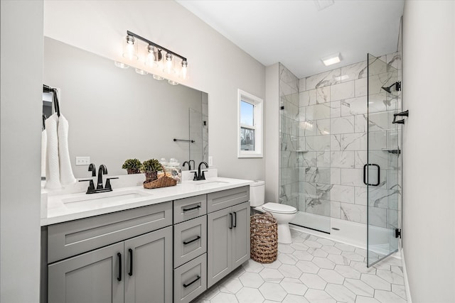 bathroom with a shower stall, toilet, double vanity, and a sink