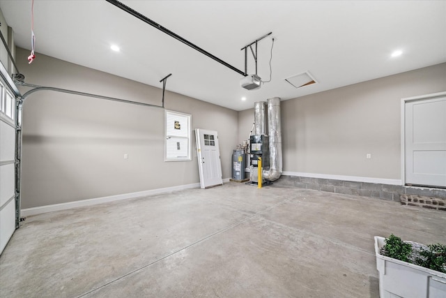 garage with recessed lighting, baseboards, a garage door opener, and water heater