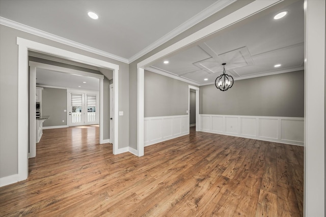 empty room with recessed lighting, crown molding, and wood finished floors