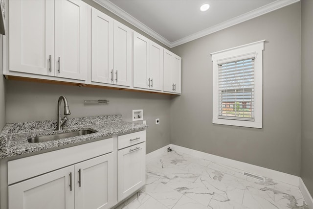 laundry room with cabinet space, electric dryer hookup, ornamental molding, washer hookup, and a sink