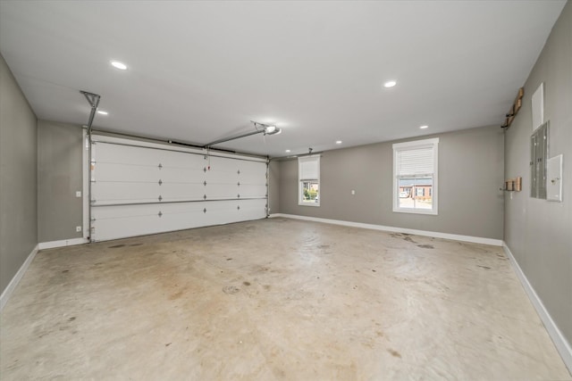 garage with recessed lighting and baseboards