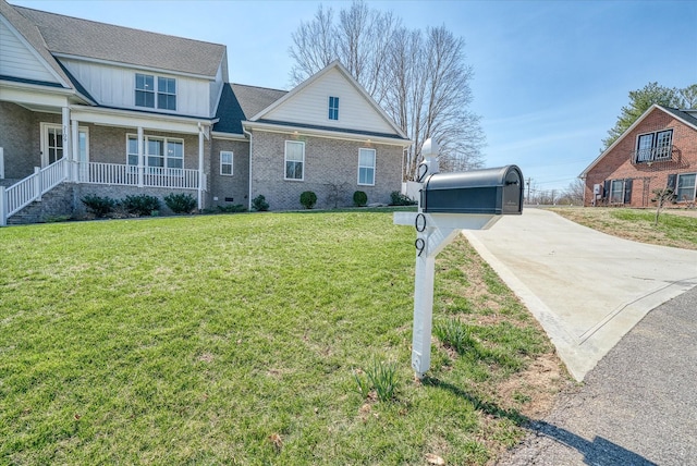 view of front of property with crawl space, covered porch, a front yard, and brick siding