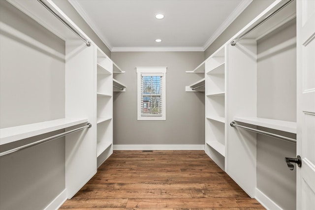 walk in closet with wood finished floors