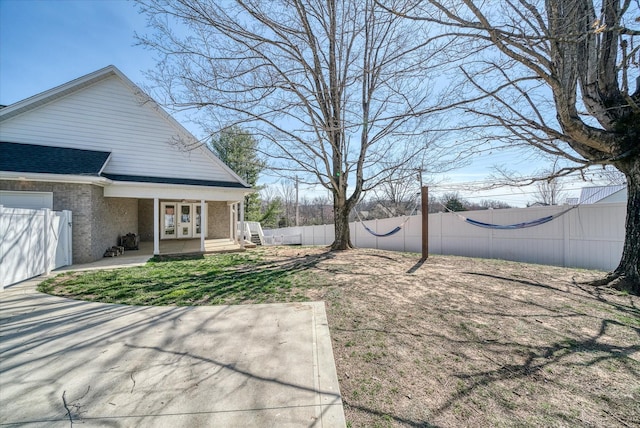 view of yard with french doors and fence