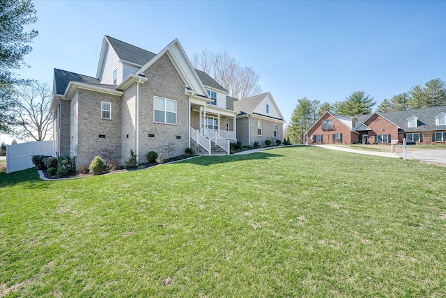 exterior space with crawl space, brick siding, a lawn, and fence