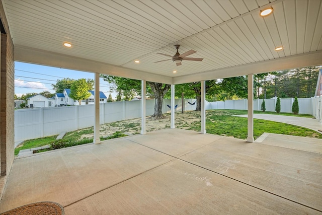 unfurnished sunroom with ceiling fan