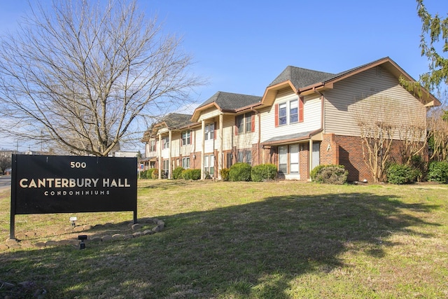 exterior space with a front yard and brick siding