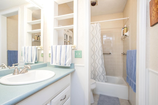 full bath with tile patterned flooring, toilet, vanity, and shower / tub combo