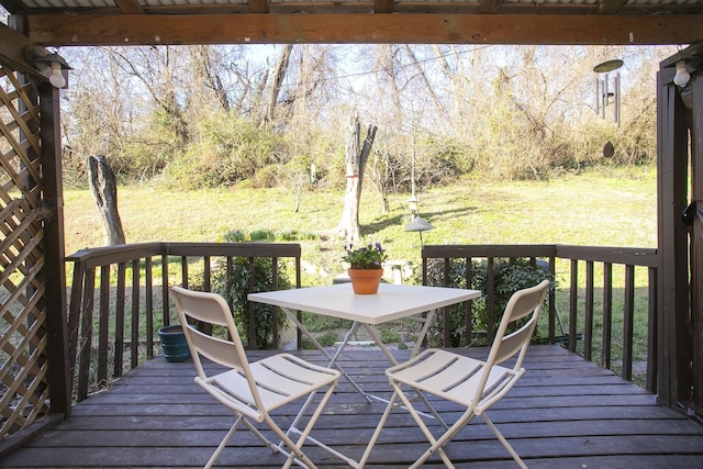 wooden terrace featuring a lawn