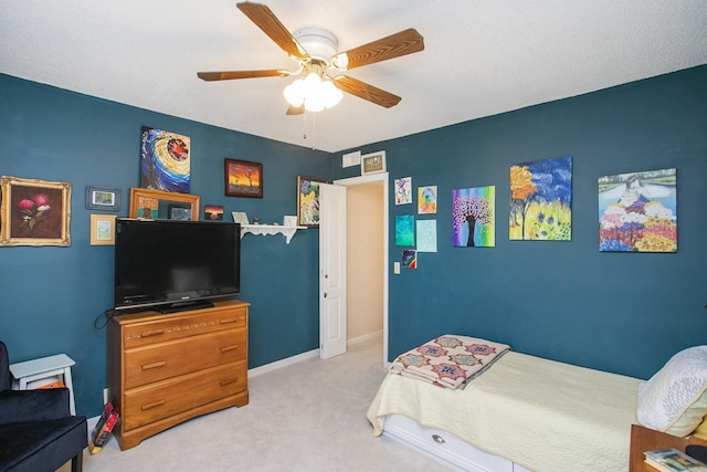 bedroom with ceiling fan, baseboards, and light carpet