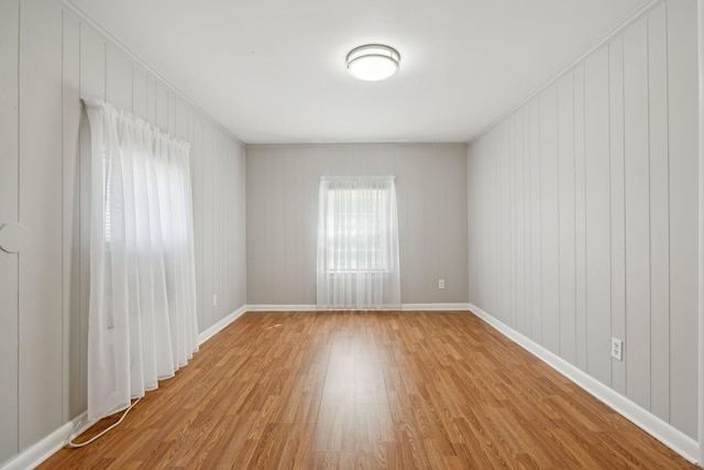 empty room with wood finished floors and baseboards