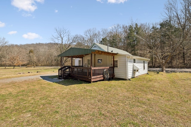 view of front of home featuring a front yard and a wooden deck