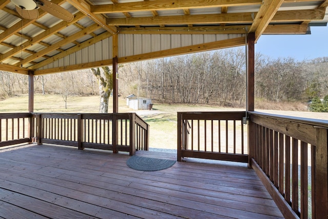 wooden terrace with an outbuilding and a storage unit