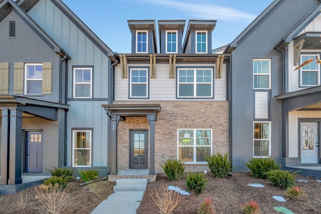 townhome / multi-family property with brick siding and board and batten siding