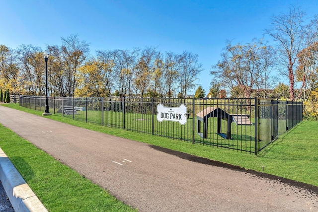 surrounding community with a yard and fence